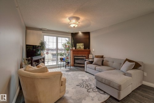 406 12110 106 Avenue, Edmonton, AB - Indoor Photo Showing Living Room With Fireplace