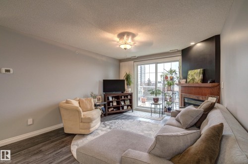 406 12110 106 Avenue, Edmonton, AB - Indoor Photo Showing Living Room With Fireplace