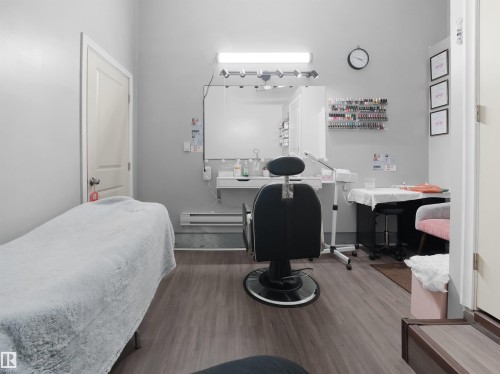 The property features light gray walls, wood-style flooring, and a white door with a silver handle - 4405 Crabapple Landing Landing, Edmonton, AB - Indoor Photo Showing Bedroom