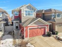 The property features a red exterior with a prominent front-facing garage - 4405 Crabapple Landing Landing, Edmonton, AB  - Outdoor 