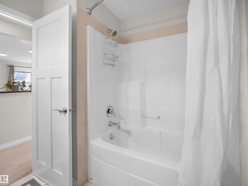 Bathroom featuring a white shower and bathtub unit with chrome fixtures - 4405 Crabapple Landing Landing, Edmonton, AB - Indoor Photo Showing Bathroom