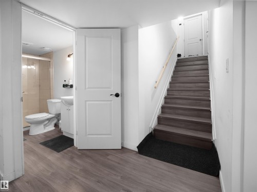 The property features a bathroom with a white toilet, white vanity with a white sink, and a shower with tiled walls and a glass enclosure - 4405 Crabapple Landing Landing, Edmonton, AB - Indoor
