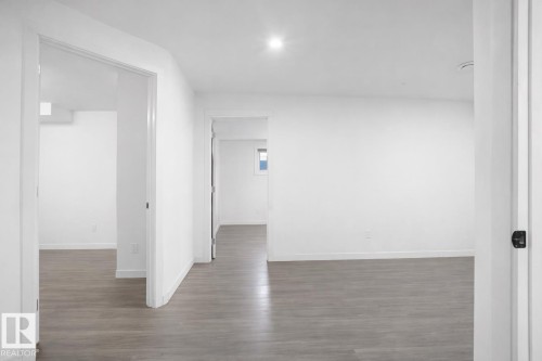 This bright interior space features light-toned flooring and white walls, creating an open and airy atmosphere - 4405 Crabapple Landing Landing, Edmonton, AB - Indoor Photo Showing Other Room