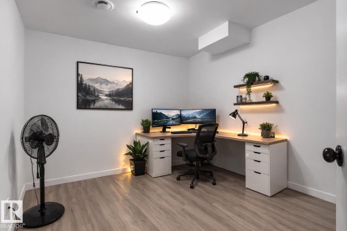 This versatile room features light-colored flooring and white walls, offering a bright and adaptable space - 4405 Crabapple Landing Landing, Edmonton, AB - Indoor Photo Showing Office