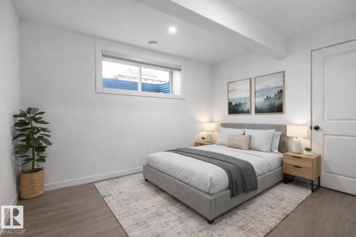 This bedroom features light-colored walls and flooring, an inset window, and a white door with a round, dark doorknob - 4405 Crabapple Landing Landing, Edmonton, AB - Indoor Photo Showing Bedroom