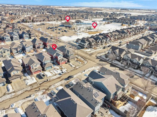 Aerial view of the neighborhood showcasing residential properties with diverse architectural styles and rooflines, including solar panels on some homes - 4405 Crabapple Landing Landing, Edmonton, AB - Outdoor With View