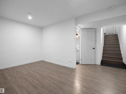 This versatile room features light-toned wood flooring, clean white walls, and recessed lighting - 4405 Crabapple Landing Landing, Edmonton, AB - Indoor Photo Showing Other Room