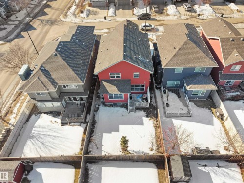 Aerial view of the property, showcasing its red exterior, multi-level deck, and fenced yard - 4405 Crabapple Landing Landing, Edmonton, AB - Outdoor