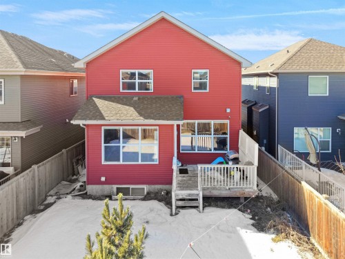 The property features a red exterior, a wooden deck, and a fenced yard - 4405 Crabapple Landing Landing, Edmonton, AB - Outdoor With Exterior