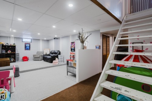 This spacious finished lower level features recessed lighting, light-colored walls, and a light carpeted area, providing a versatile space - 8707 151 Avenue, Edmonton, AB - Indoor
