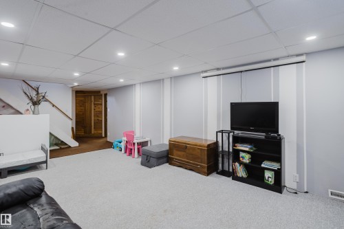 Expansive room featuring light gray walls, recessed lighting, and a neutral carpeted floor - 8707 151 Avenue, Edmonton, AB - Indoor Photo Showing Other Room