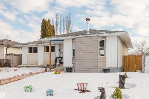 The property features a ranch-style exterior with a combination of light-colored siding and grey shake siding - 8707 151 Avenue, Edmonton, AB - Outdoor
