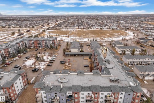 This property features a multi-story building with a grey roof and balconies - 320 392 Silver Berry Road, Edmonton, AB - Outdoor With View