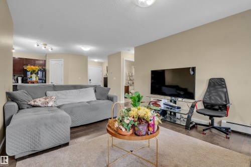 Open concept living area featuring hardwood flooring and light-colored walls - 320 392 Silver Berry Road, Edmonton, AB - Indoor Photo Showing Living Room