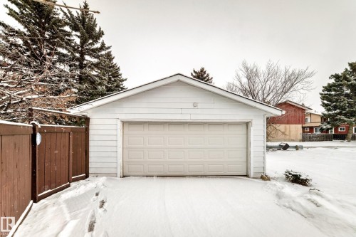 Detached garage with white siding and a white garage door - 11415 32 Avenue, Edmonton, AB - Outdoor With Exterior