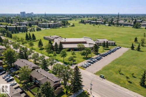 Aerial view highlighting the property's proximity to large green spaces and mature trees - 11415 32 Avenue, Edmonton, AB - Outdoor With View