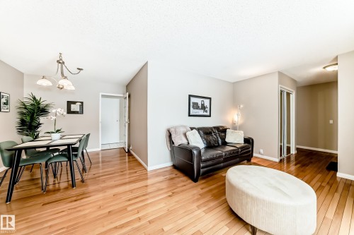 Living area featuring hardwood floors and neutral-toned walls - 11415 32 Avenue, Edmonton, AB - Indoor Photo Showing Living Room