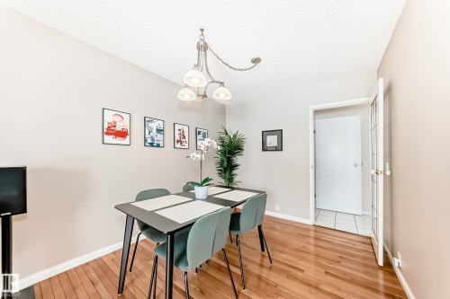 This room features hardwood floors and light-colored walls, providing a bright and inviting atmosphere - 11415 32 Avenue, Edmonton, AB - Indoor
