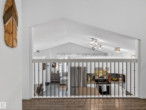 The property offers an open concept design with vaulted ceilings and track lighting - 1665 Tompkins Place, Edmonton, AB - 