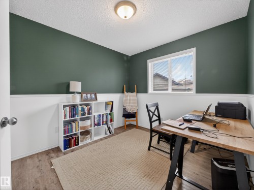 This room features hardwood style flooring, a window with blinds, and walls with a two-tone paint scheme - 1665 Tompkins Place, Edmonton, AB - Indoor Photo Showing Office