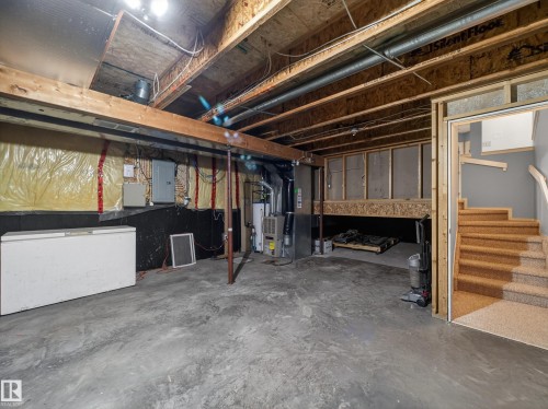 The property features a utility area with exposed ceiling joists and visible ductwork - 1665 Tompkins Place, Edmonton, AB - Indoor Photo Showing Basement