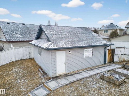 The property features a detached structure with siding, a gabled roof, and two windows - 1665 Tompkins Place, Edmonton, AB - Outdoor With Exterior