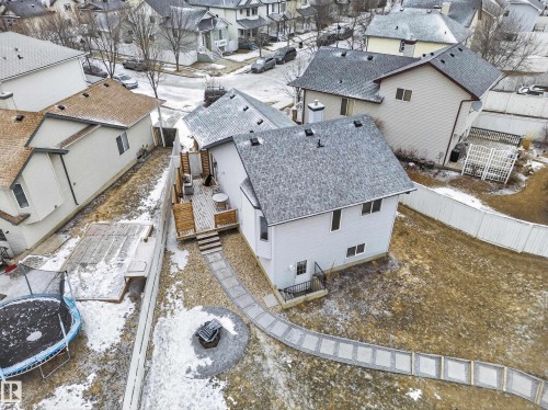 The property features a spacious backyard with a patio, a stone pathway, and a fire pit area - 1665 Tompkins Place, Edmonton, AB - Outdoor