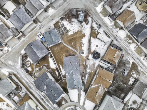Aerial view showcasing the property within a residential setting, featuring various roof styles and surrounding roadways - 1665 Tompkins Place, Edmonton, AB - Other