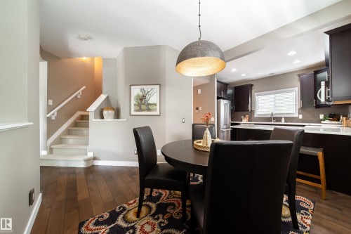 This dining area features hardwood floors and a modern pendant light fixture - 3451 Cutler Crescent, Edmonton, AB - Indoor