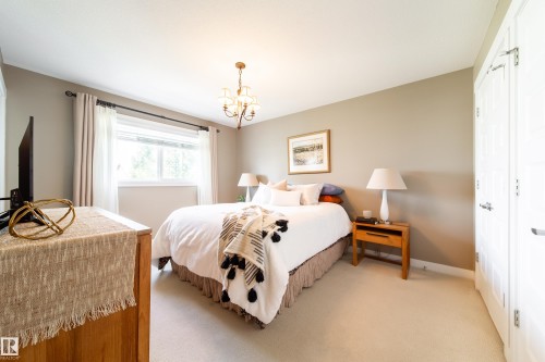 This room features light-colored walls, carpeted flooring, and a window with curtains - 3451 Cutler Crescent, Edmonton, AB - Indoor Photo Showing Bedroom