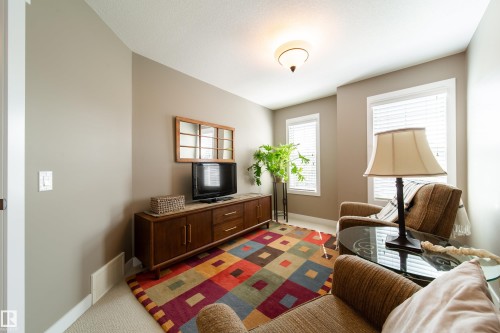 This inviting room features two windows with blinds, a ceiling-mounted light fixture, and neutral-toned walls - 3451 Cutler Crescent, Edmonton, AB - Indoor
