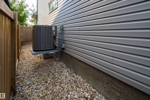 The property features light gray horizontal siding and a gravel pathway - 3451 Cutler Crescent, Edmonton, AB - Outdoor