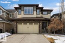 The property features a two-car garage, a paved driveway, and stone accents on the facade - 13024 206 Street, Edmonton, AB  - Outdoor 