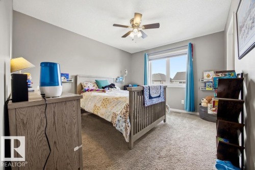 This room features neutral-toned walls and carpeted flooring, creating a versatile space - 13024 206 Street, Edmonton, AB - Indoor Photo Showing Bedroom
