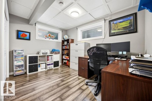 The room features light gray walls, a drop ceiling, and wood-look flooring - 13024 206 Street, Edmonton, AB - Indoor Photo Showing Office