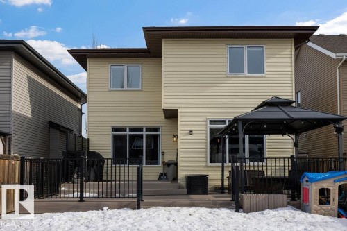 The property features a private deck with a black metal railing and a dark-colored gazebo with string lights - 13024 206 Street, Edmonton, AB - Outdoor With Deck Patio Veranda With Exterior