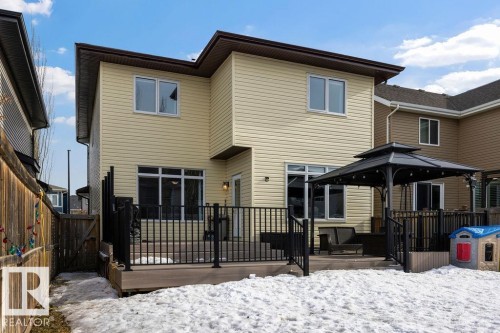 The property features a private deck with dark railings, providing an outdoor living space - 13024 206 Street, Edmonton, AB - Outdoor With Deck Patio Veranda