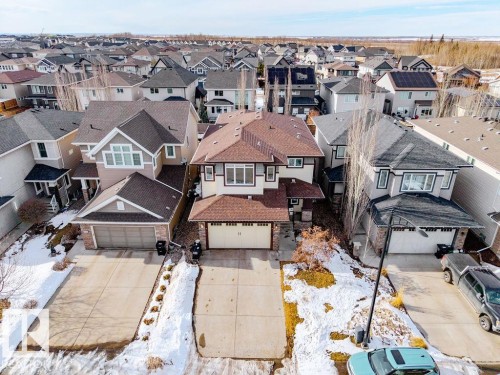 The property features a two-story design with a brown shingled roof and an attached garage - 13024 206 Street, Edmonton, AB - Outdoor With Facade