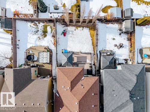 Aerial view of the property with a brown shingle roof, a backyard featuring a deck, and an additional structure with a gray roof - 13024 206 Street, Edmonton, AB - Outdoor With Deck Patio Veranda