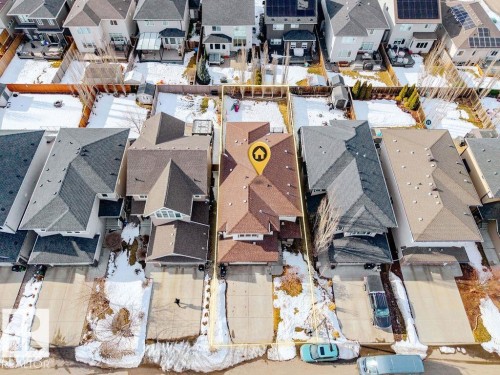 Aerial view of the property, showcasing its brown roof, a white shed in the backyard, and a paved driveway - 13024 206 Street, Edmonton, AB - Outdoor