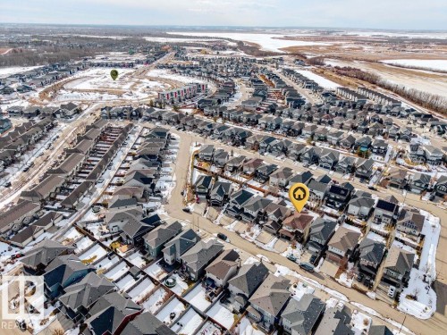 Aerial view of the surrounding residential development, featuring numerous properties with dark roofs and light-colored siding - 13024 206 Street, Edmonton, AB - Outdoor With View