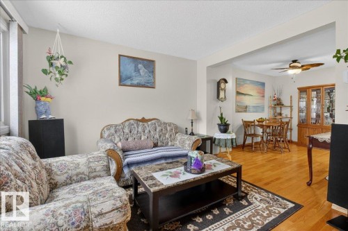 This inviting living area features light-colored walls and polished wood flooring throughout - 2 Mcleod Place, Edmonton, AB - Indoor Photo Showing Living Room