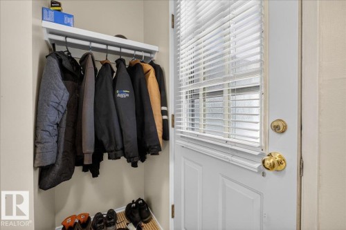 Entryway featuring a white door with a window and horizontal blinds, and a closet with a hanging rod and shelf - 2 Mcleod Place, Edmonton, AB - Indoor With Storage