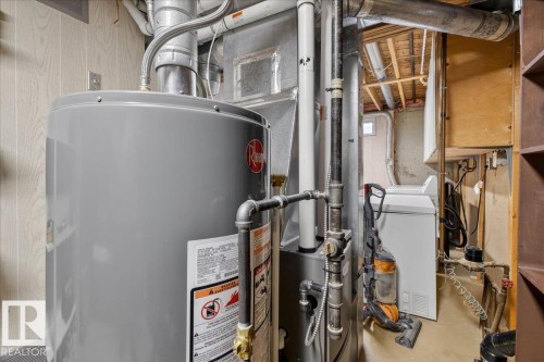 The utility area features a water heater, furnace, and a washer - 2 Mcleod Place, Edmonton, AB - Indoor Photo Showing Basement