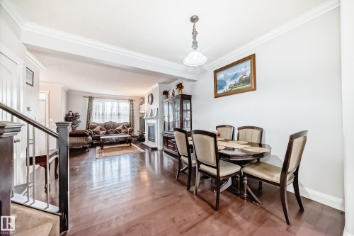 The property features an open layout with rich hardwood flooring throughout - 2 12042 101 Street, Edmonton, AB - Indoor Photo Showing Dining Room