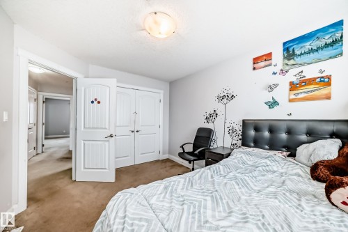 Bedroom featuring a light-colored carpet, white walls, and a ceiling light fixture - 2 12042 101 Street, Edmonton, AB - Indoor Photo Showing Bedroom