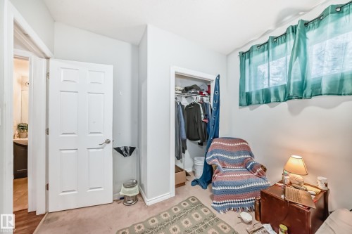 This room features light-colored walls and a carpeted floor - 2 12042 101 Street, Edmonton, AB - Indoor