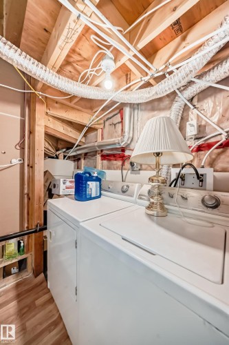 Laundry area featuring a top-loading washing machine and a dryer - 2 12042 101 Street, Edmonton, AB - Indoor Photo Showing Laundry Room