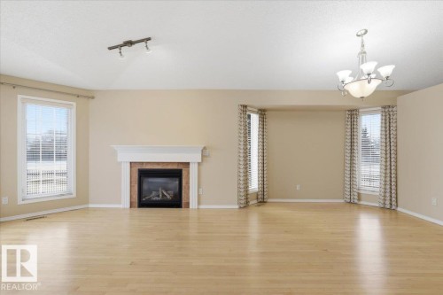 4 102 Bridgeport Crossing, Leduc, AB - Indoor Photo Showing Living Room With Fireplace