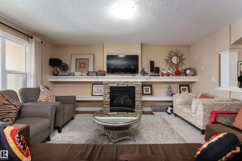 729 37A Avenue, Edmonton, AB - Indoor Photo Showing Living Room With Fireplace